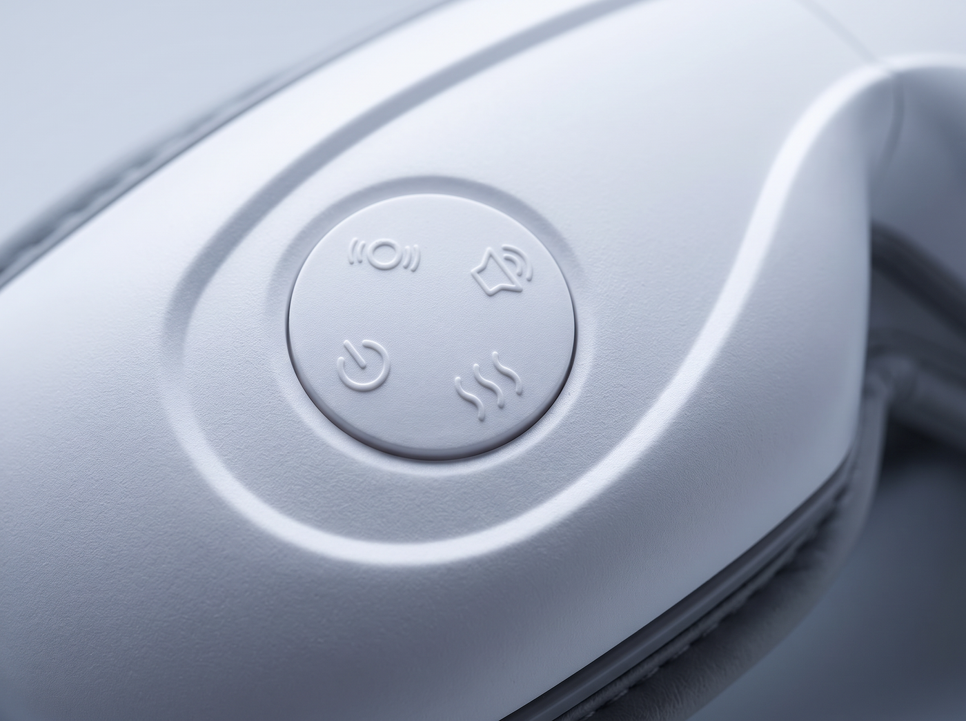 Macro detail of the single control button on the Heated Eye Massager.